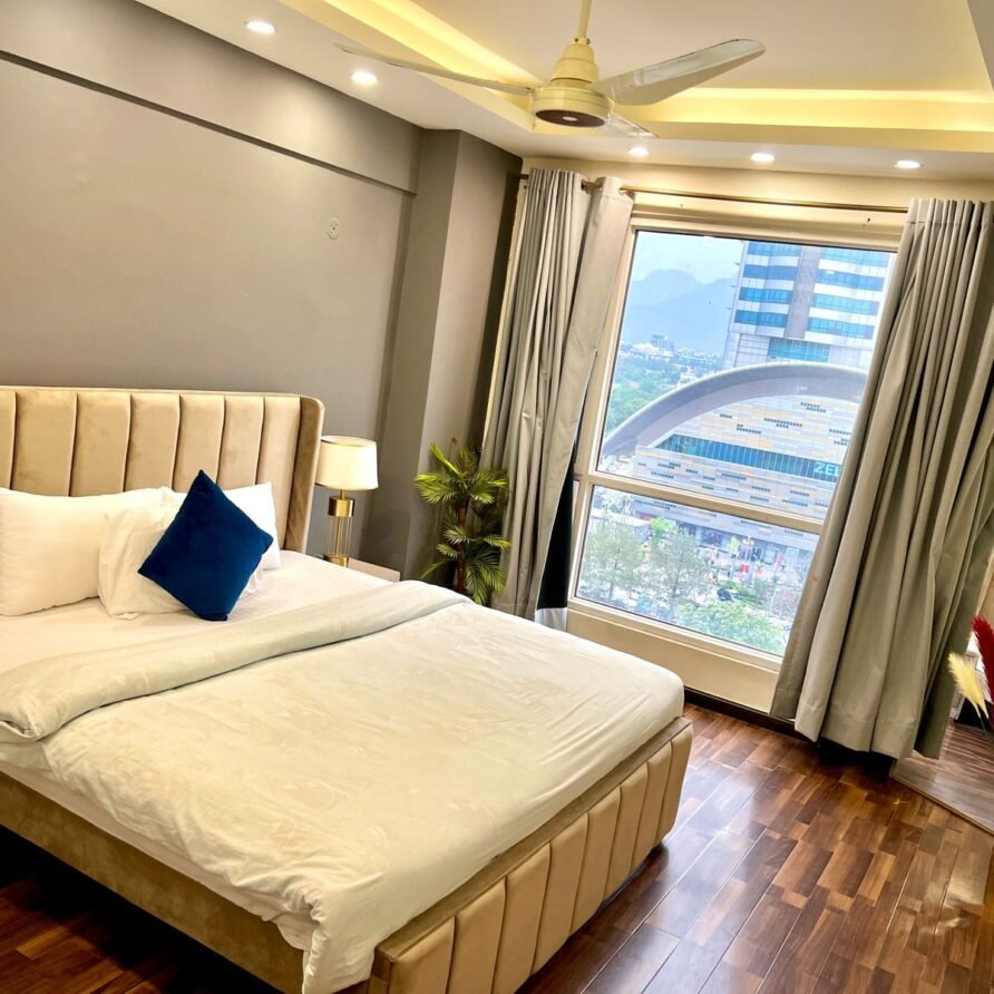 Plush master bedroom with warm lighting in top-rated Airbnb apartment near Centaurus Mall
